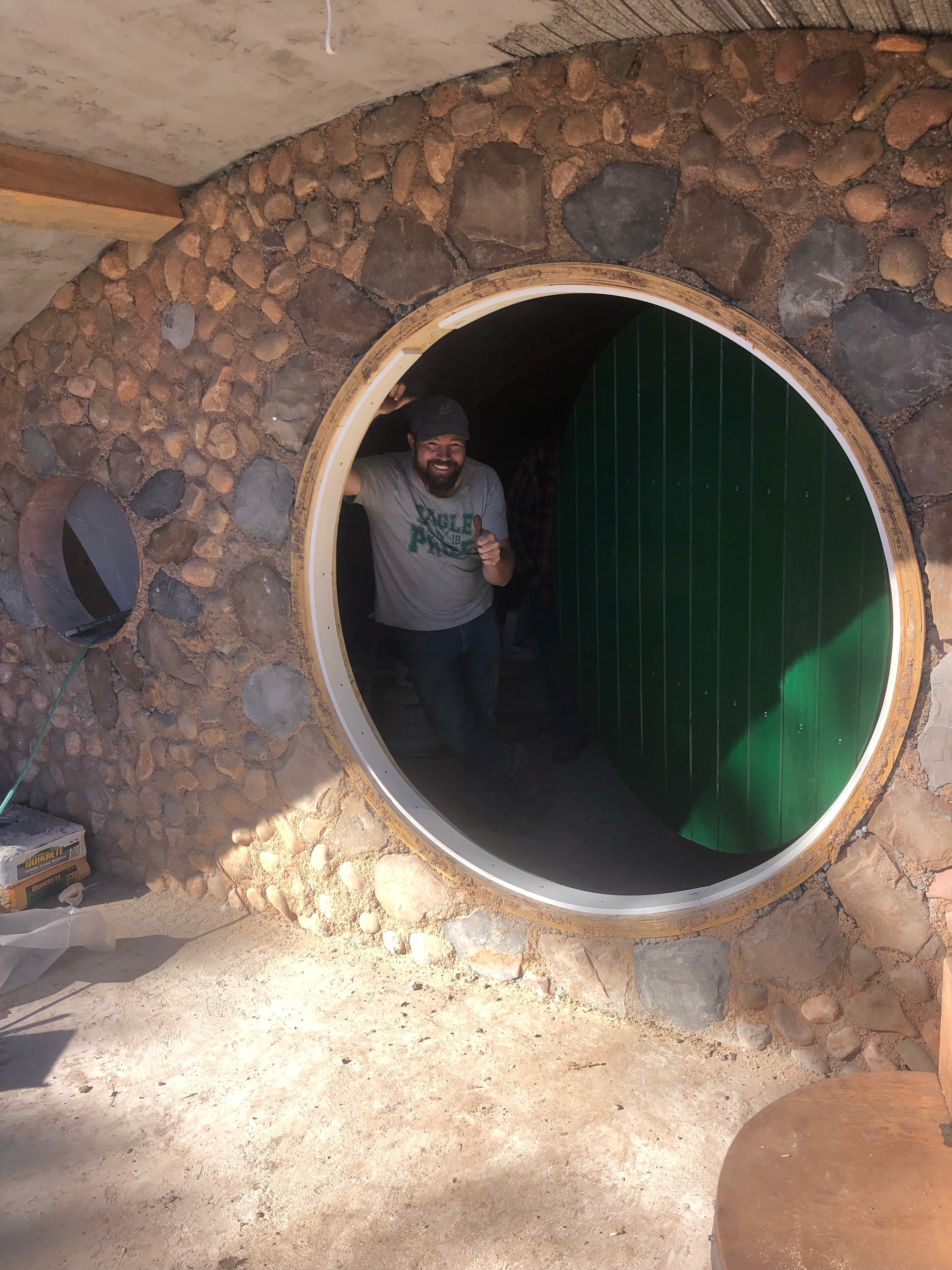 Guest crawling through the Hobbit Hole round entrance