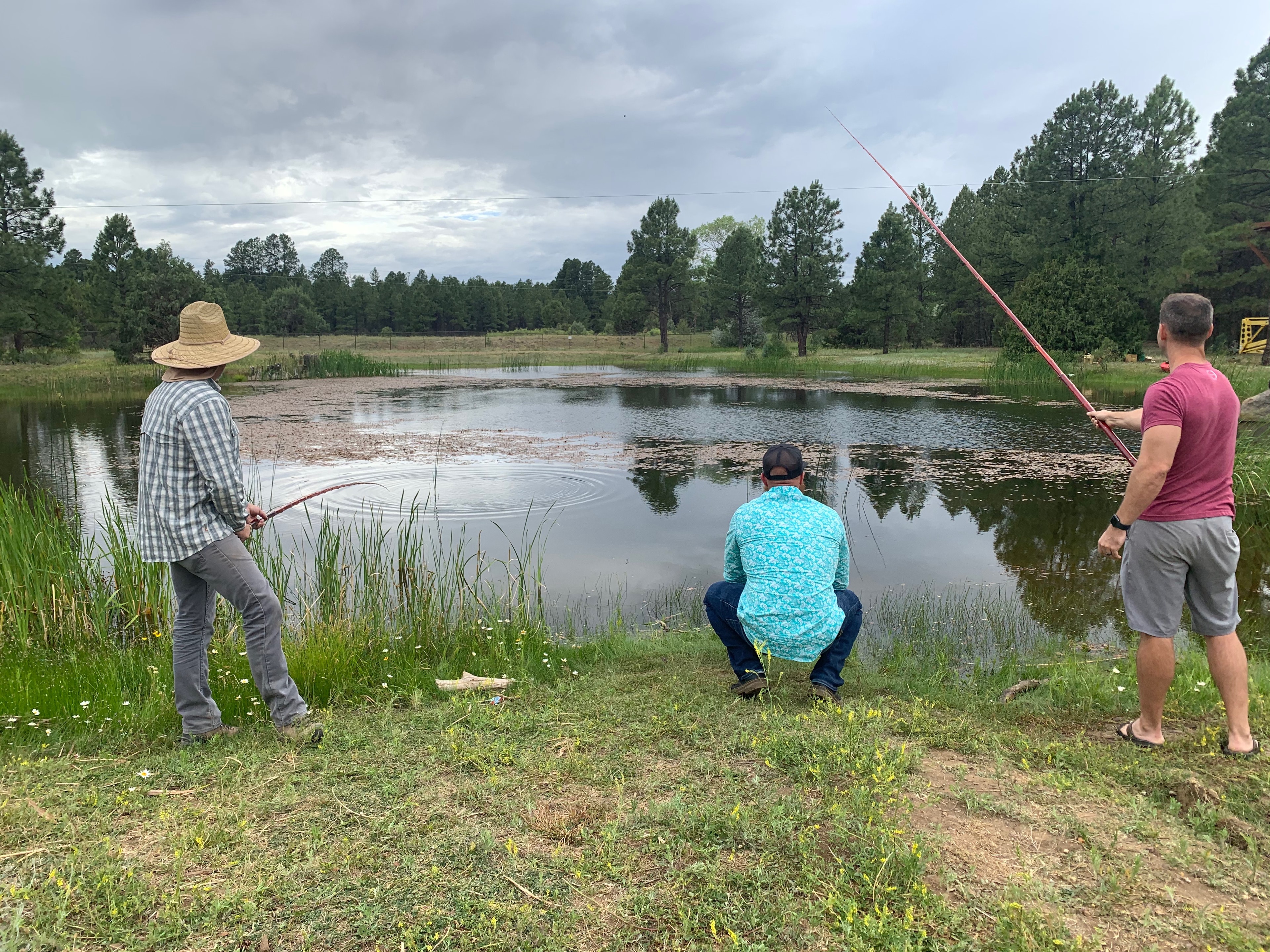 Three guests fishing together at the Let-N-Go Ranch pond